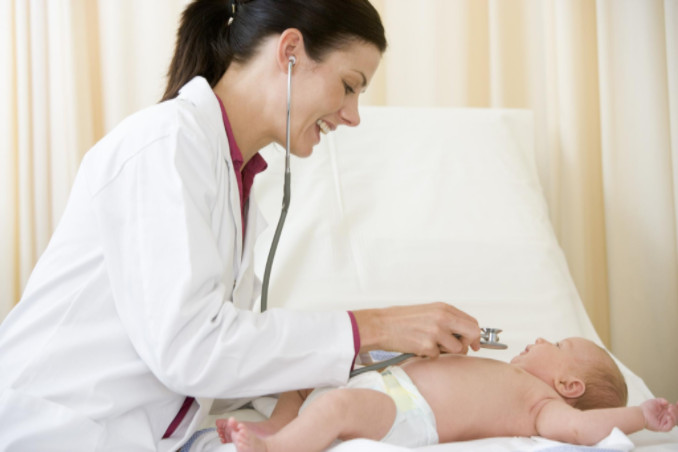 Doctor examining newborn: All About Women Pregnancy and Prenatal Care Blog