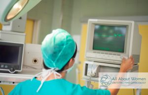 nurse checking monitors during da Vinci robotic surgery